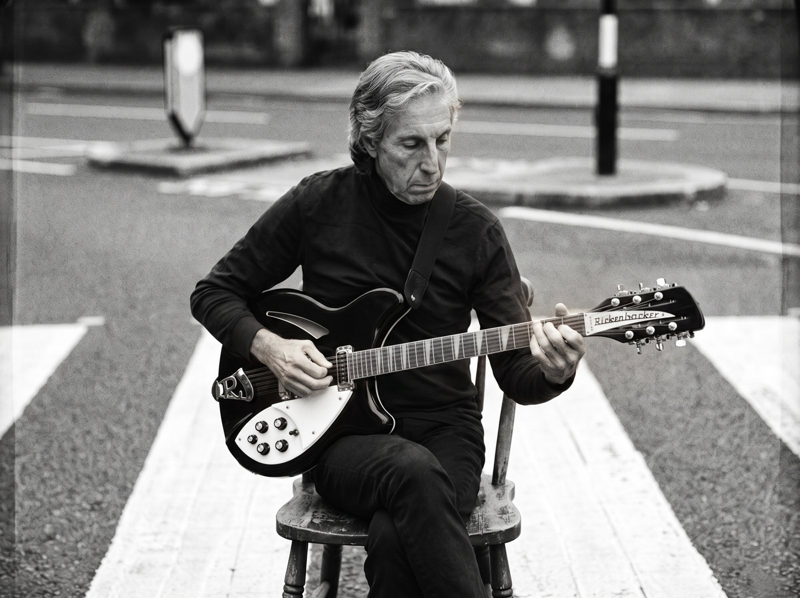 Beat 7: close on hands settling onto the twelve-string, the held breath